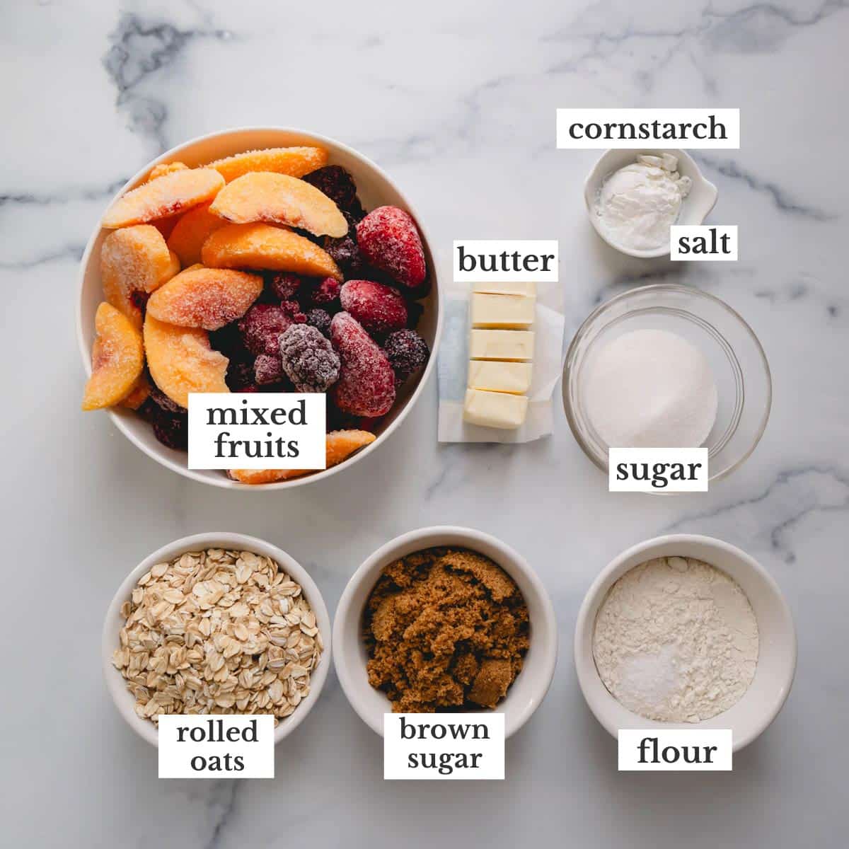 Ingredients needed to make an easy fruit crisp recipe with mixed fruits.