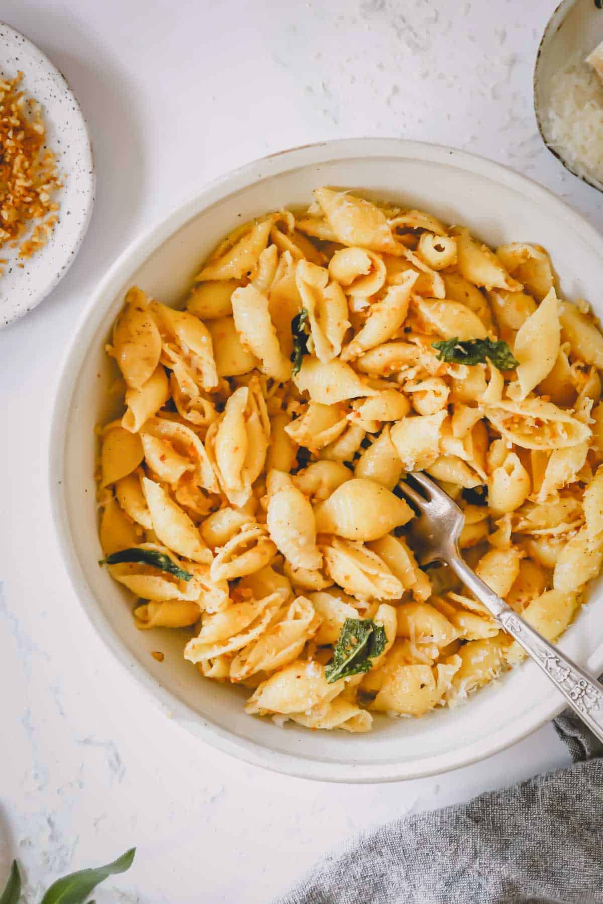 A bowl of brown butter pasta with a fork sticking out.