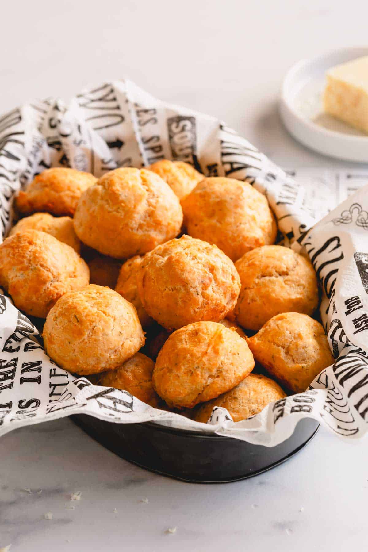 A platter of golden round cheese puffs piled up.