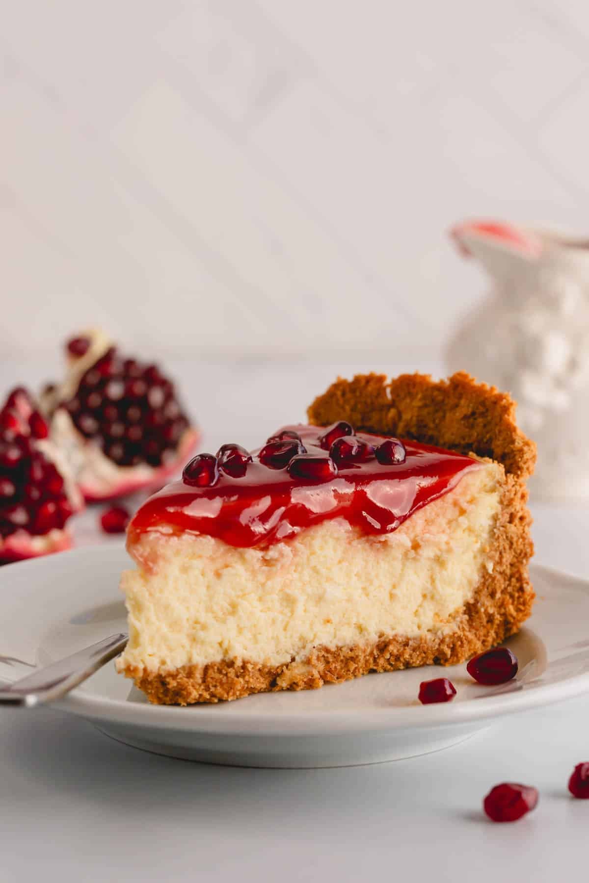 A slice of pomegranate cheesecake on a plate.