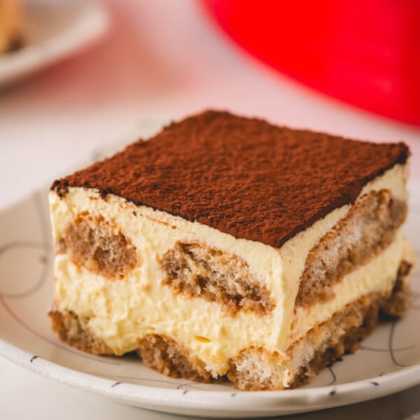 A square of classic tiramisu on a plate.