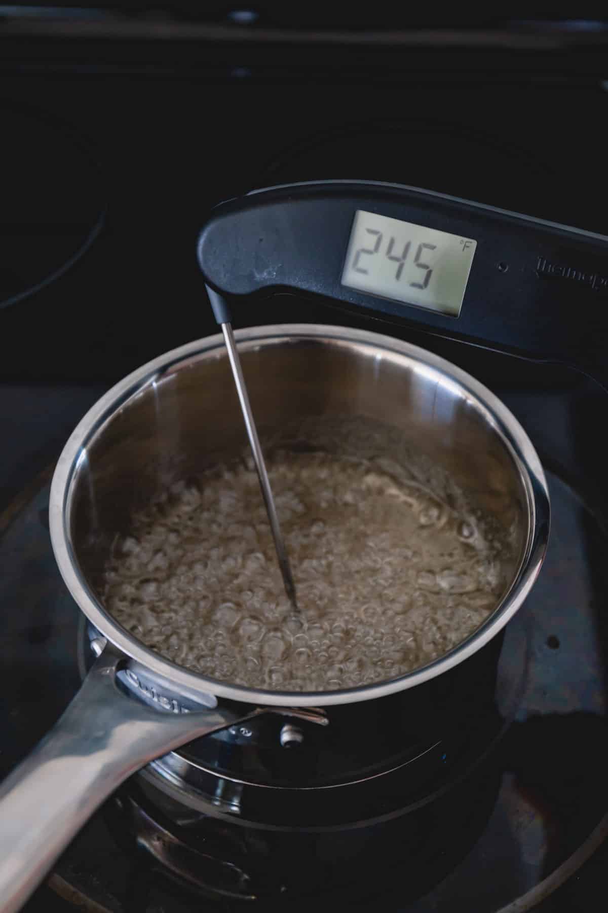 Boiling water with a thermometer reading 245 degrees Fahrenheit.
