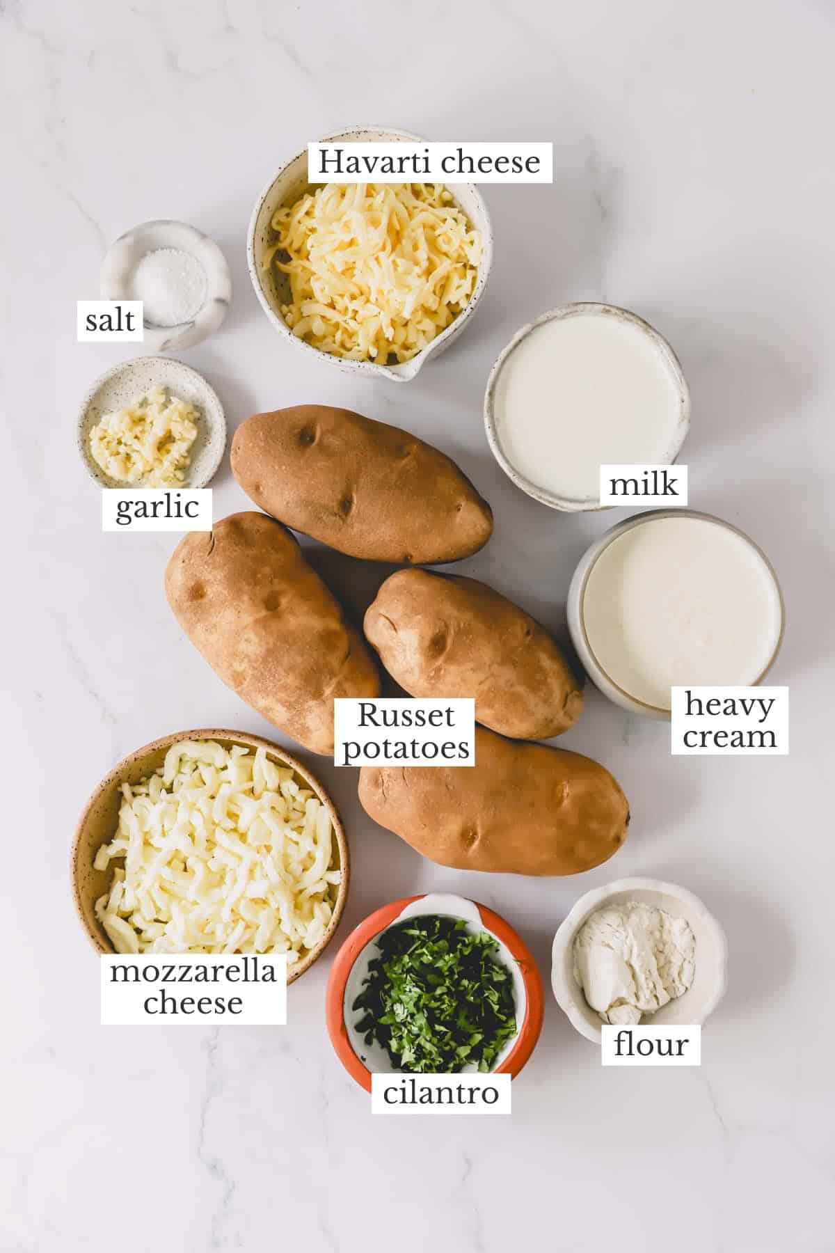 Ingredients needed to make cheesy scalloped potatoes.