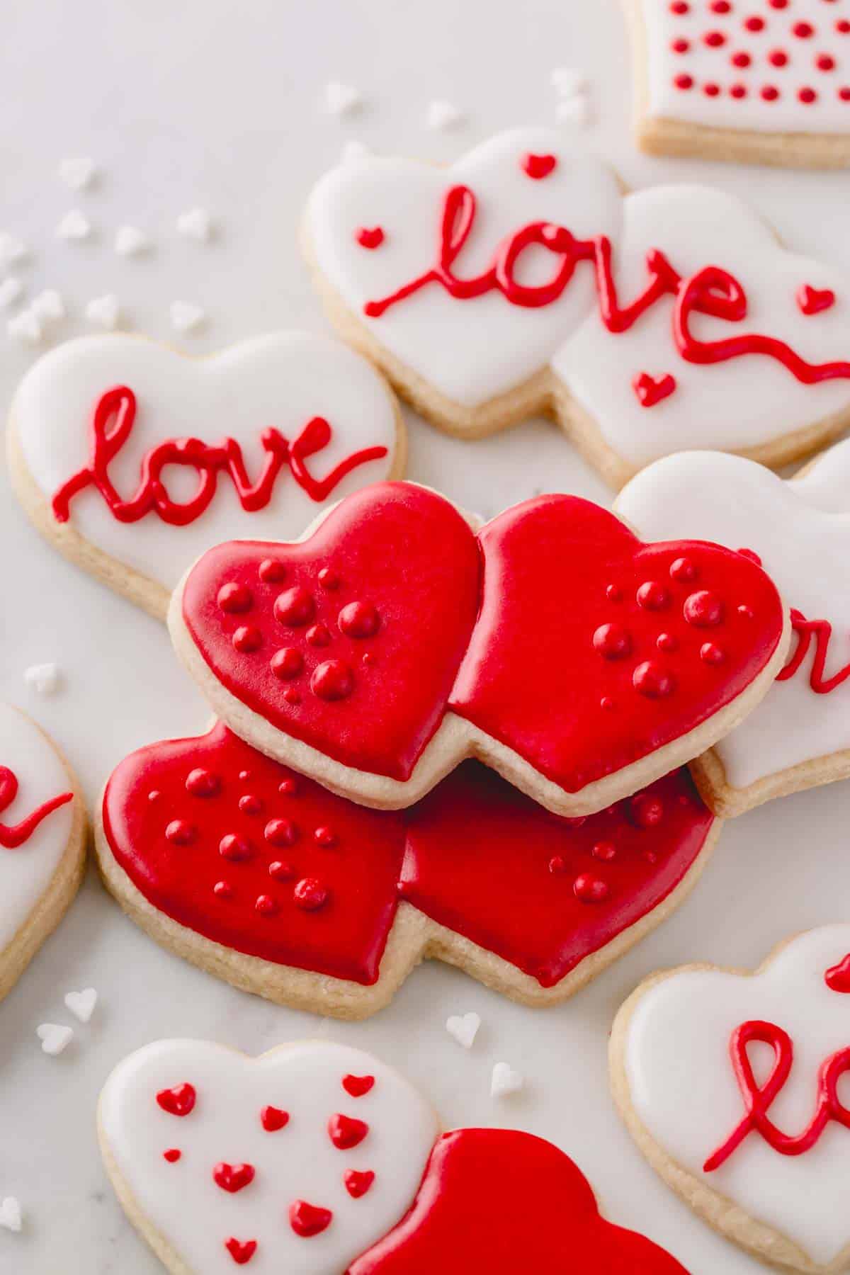 Heart-shaped Valentine's Day sugar cookies with red and white icing.