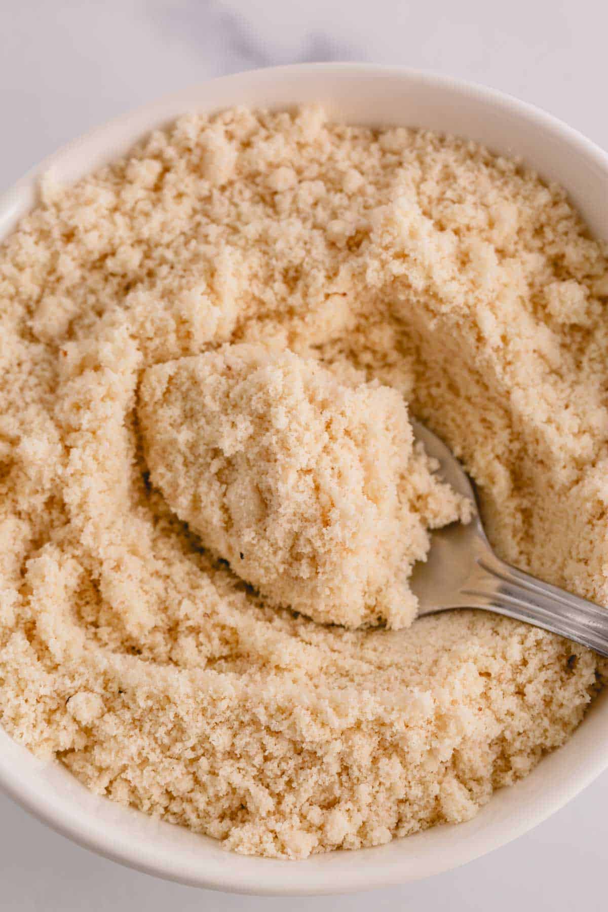 Almond flour in a white bowl.