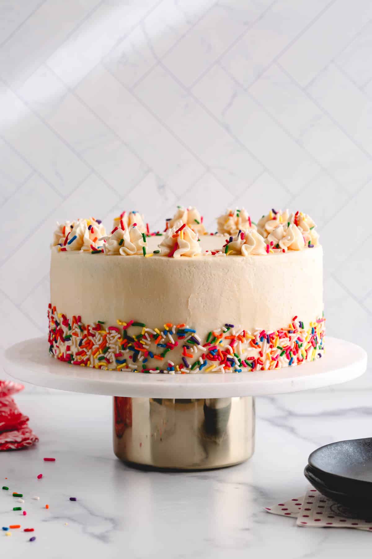Vanilla cake decorated with Russian buttercream and sprinkles.