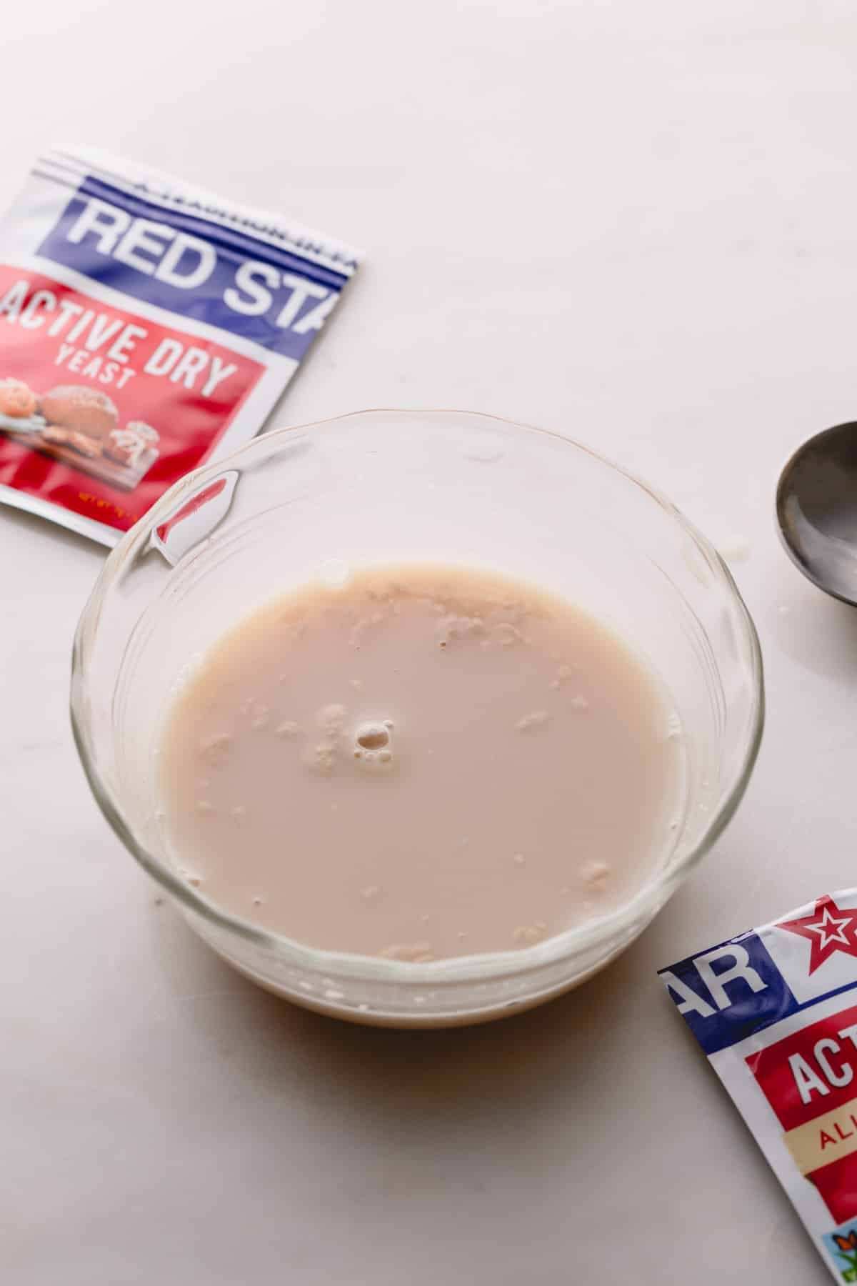 A small bowl of mixture of yeast, water and sugar just mixed.