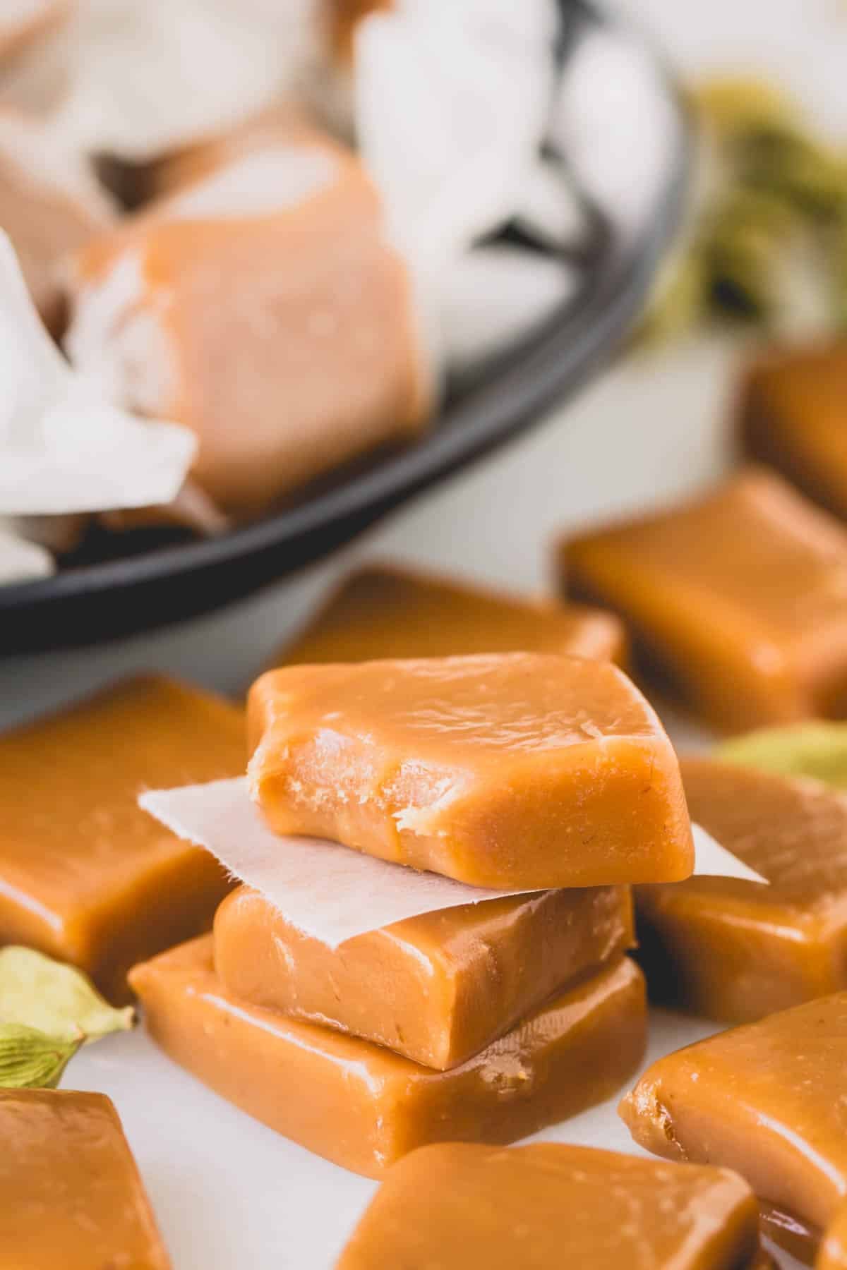 Cardamom caramel candies with one missing a corner.