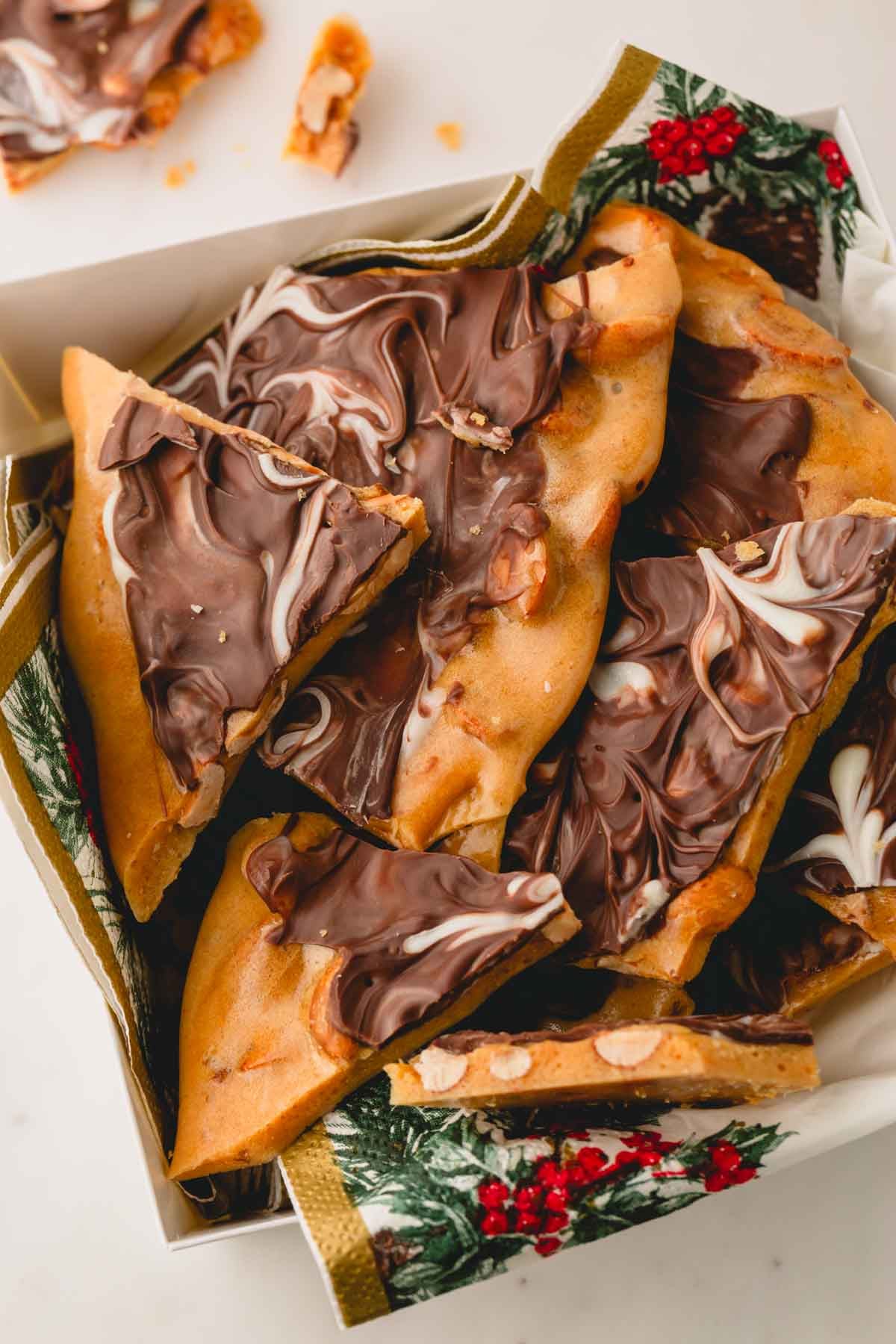 A box of chocolate peanut brittle pieces.