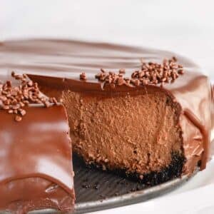 Supreme chocolate cheesecake with a slice missing.