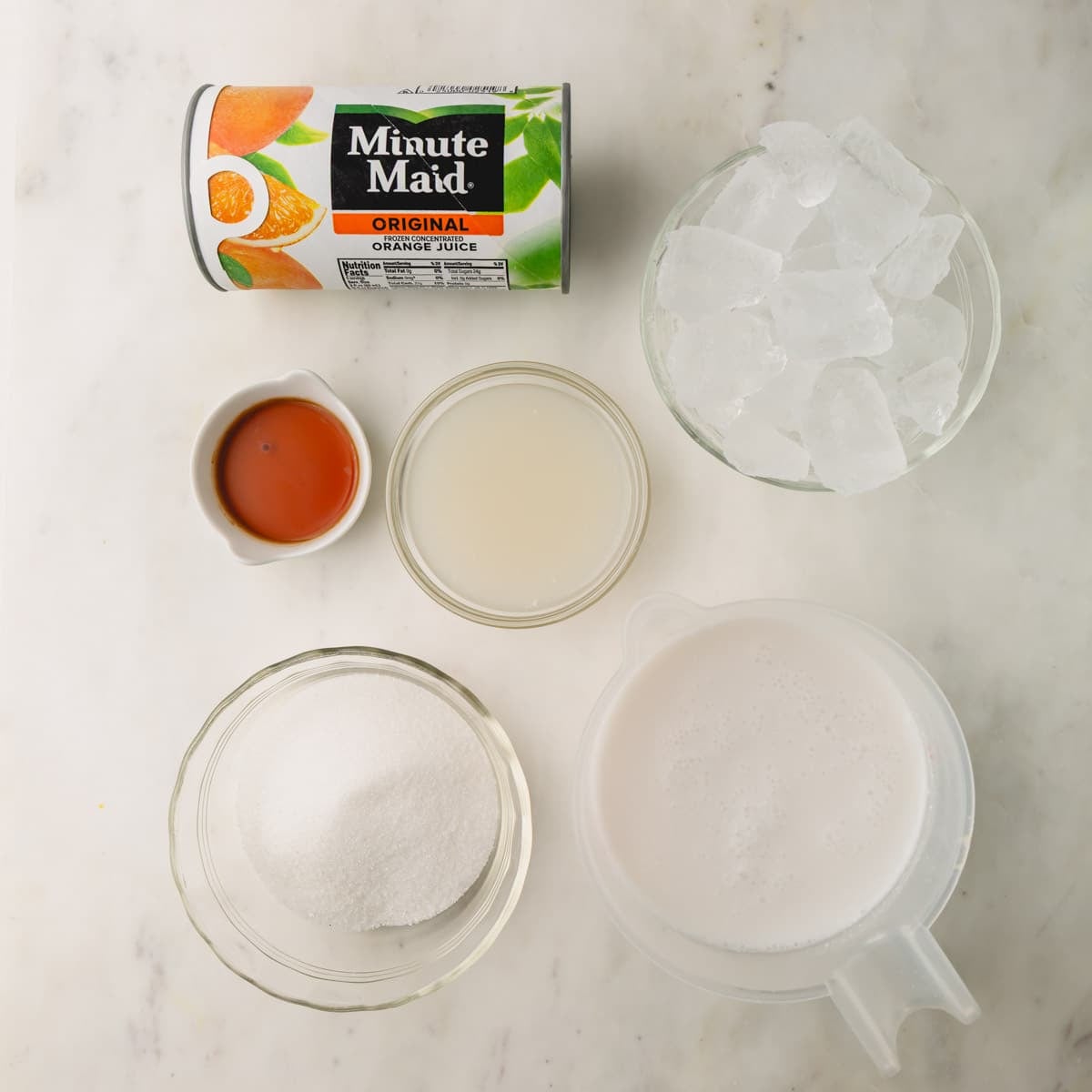 Ingredients to make a coconut orange Julius drink.