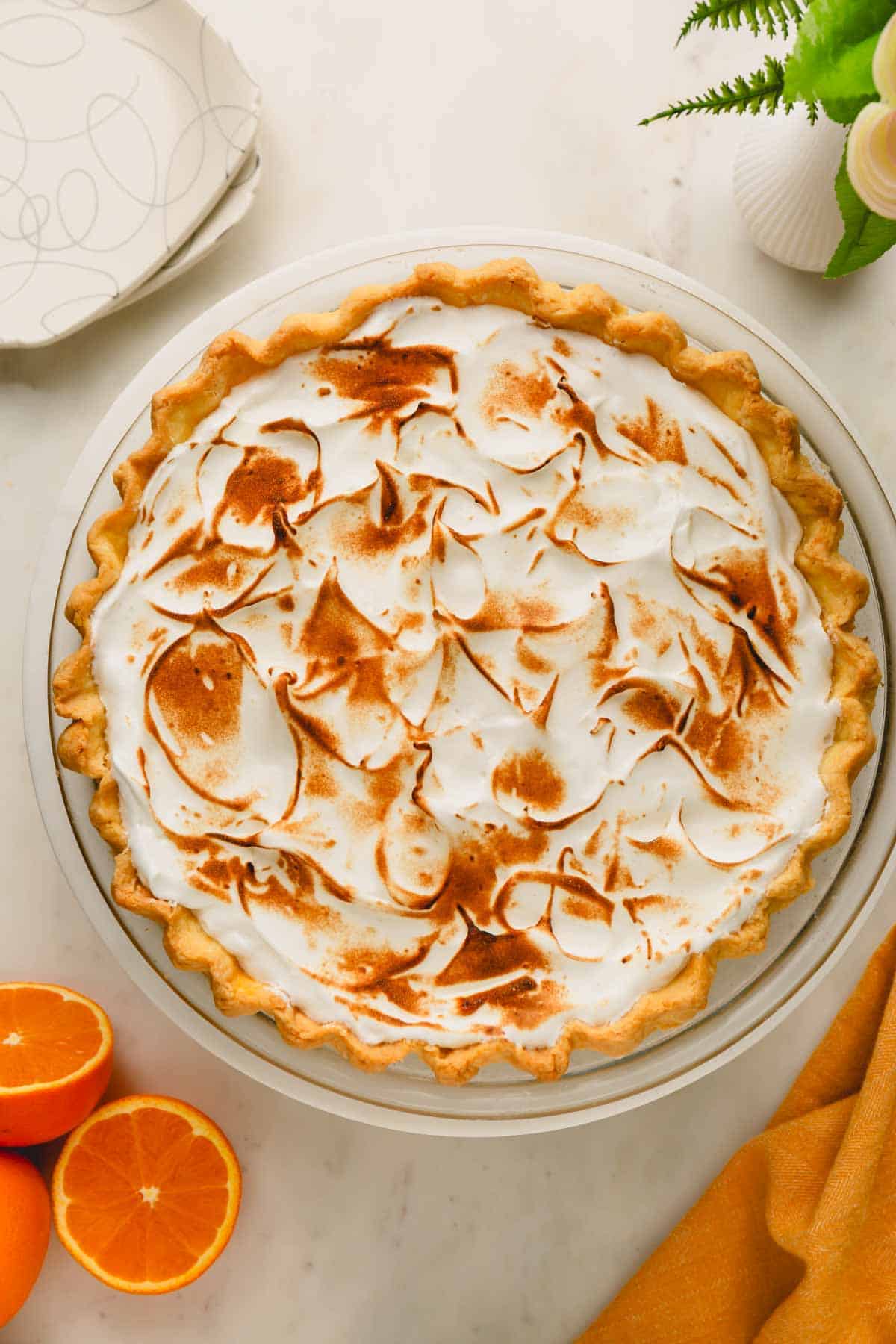 An orange meringue pie with a toasted meringue topping.