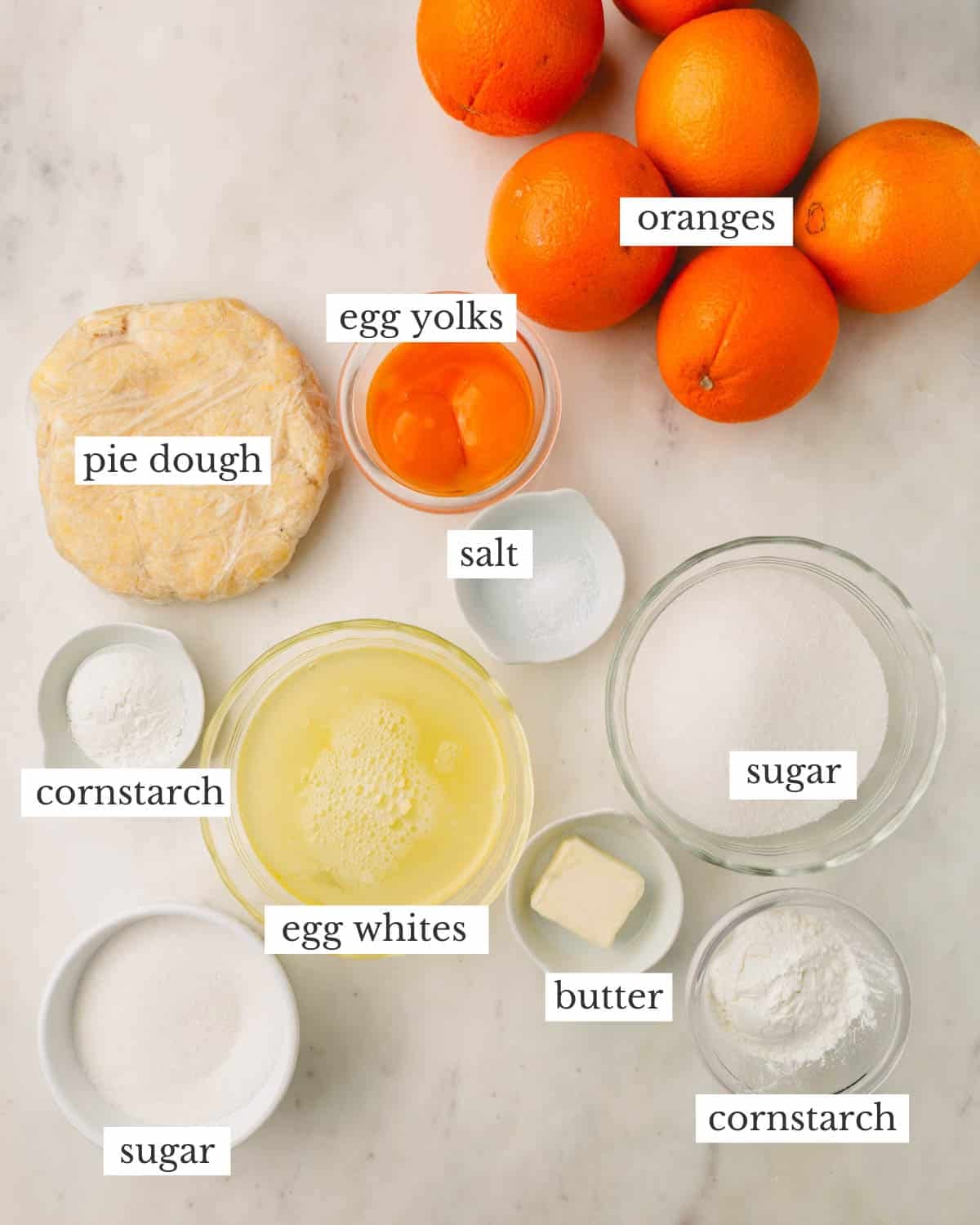 Ingredients to make an orange meringue pie.
