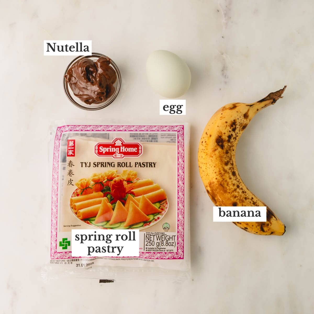 Nutella, an egg, a ripe banana, and a bag of spring roll wrappers.