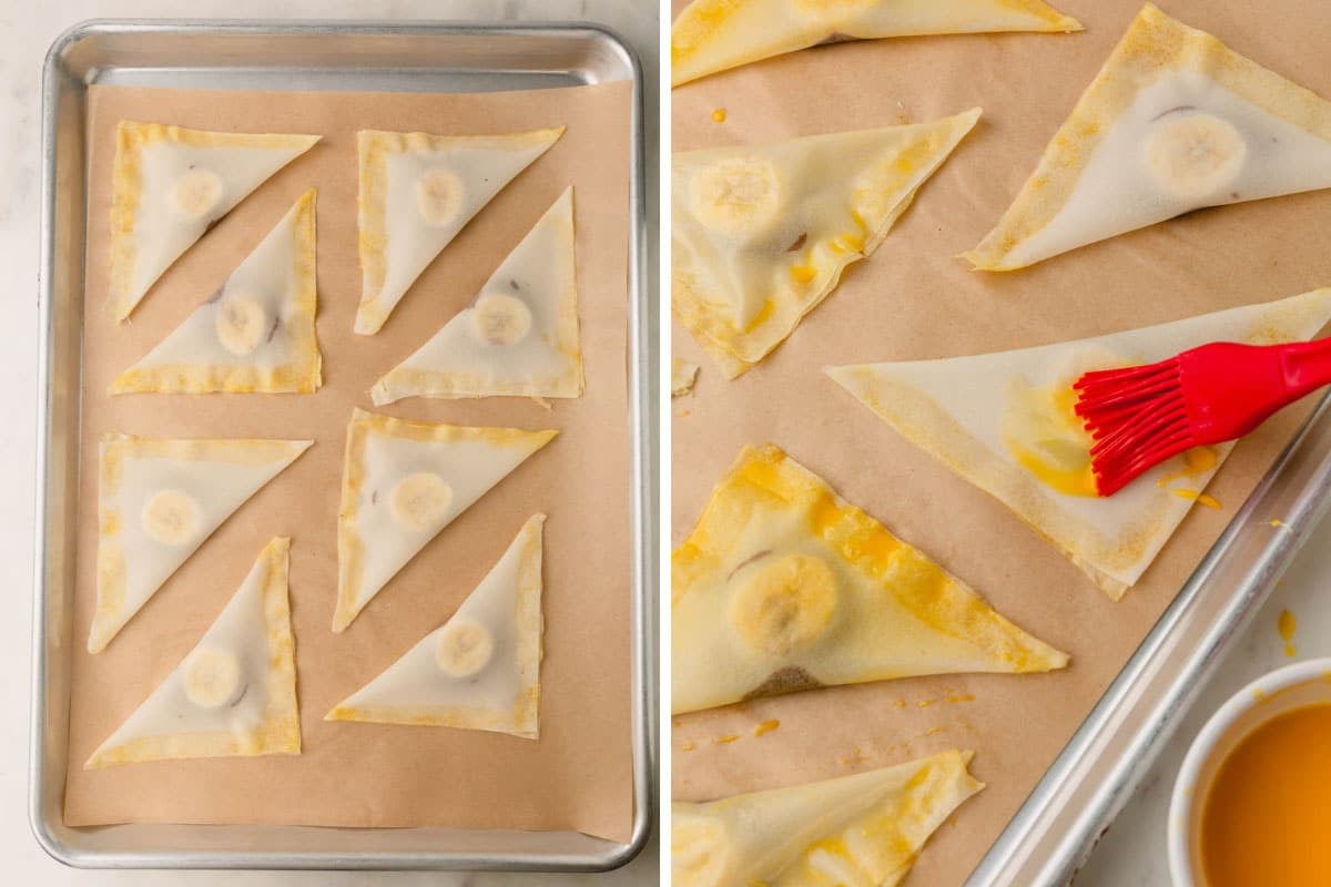 Banana Nutella wontons on a parchment paper lined baking sheet being brushed with egg wash.