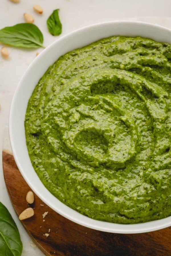 A bowl of large batch basil pesto.
