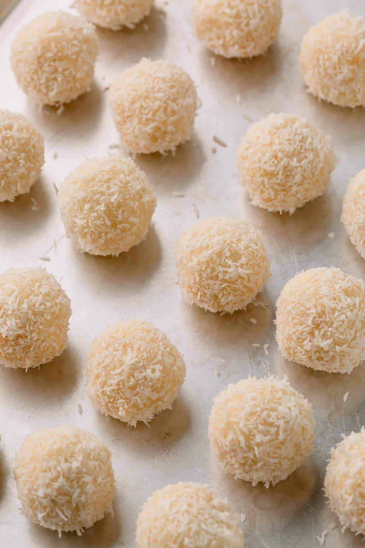 Desiccated coconut covered coconut balls.