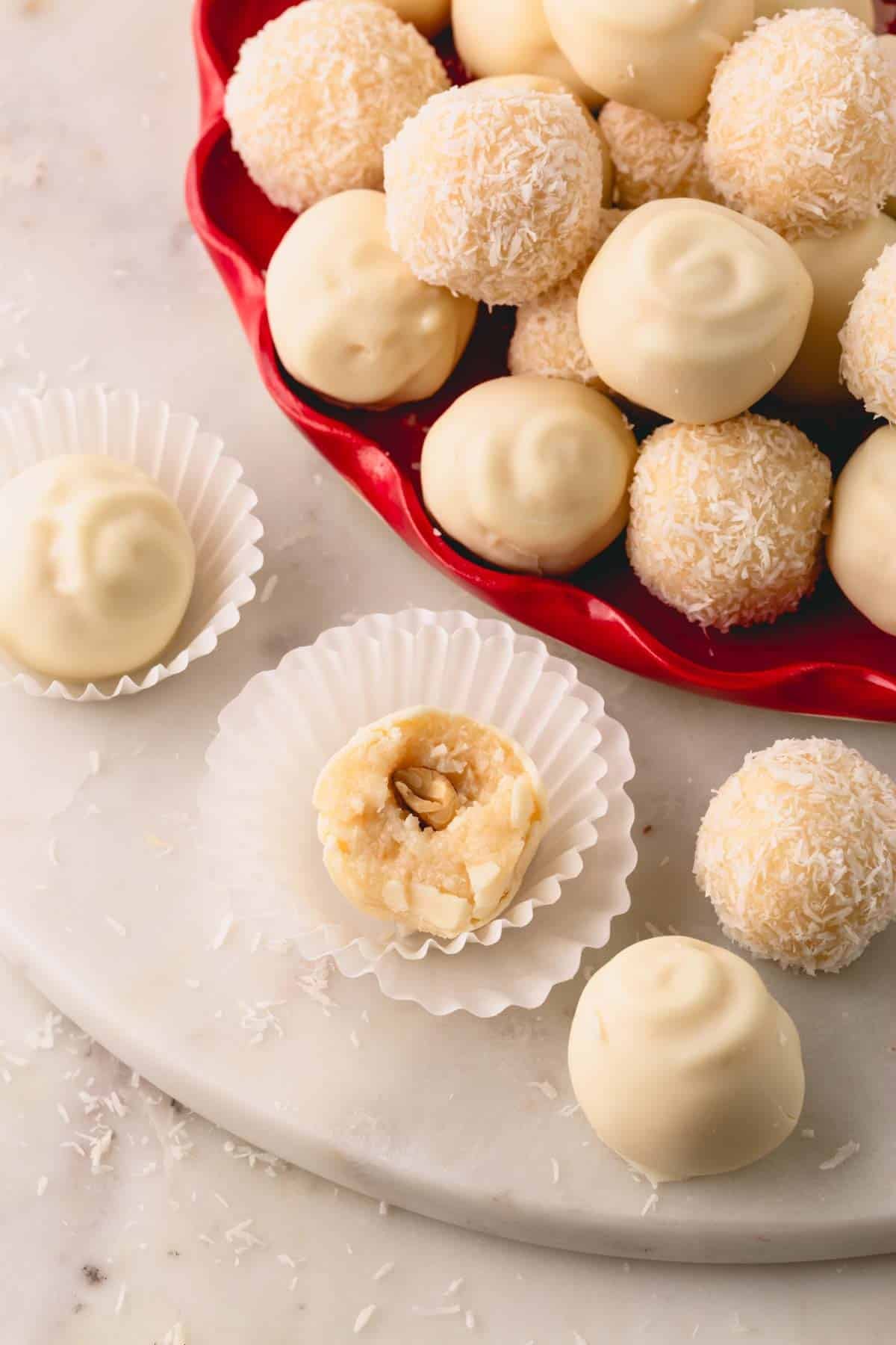 Coconut almond balls, some coated in white chocolate and others with desiccated coconut.