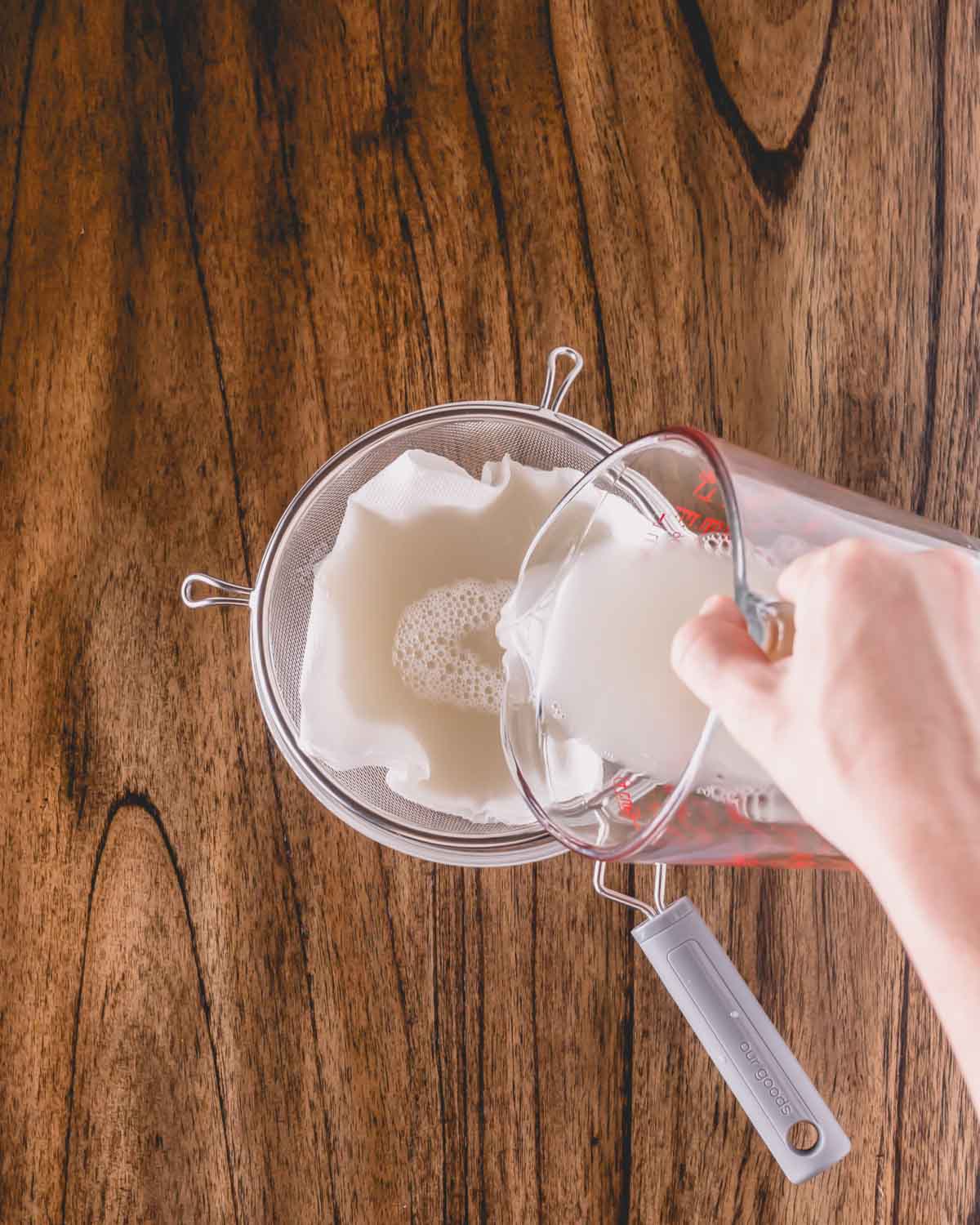 Oyster juice being strained in a seive.