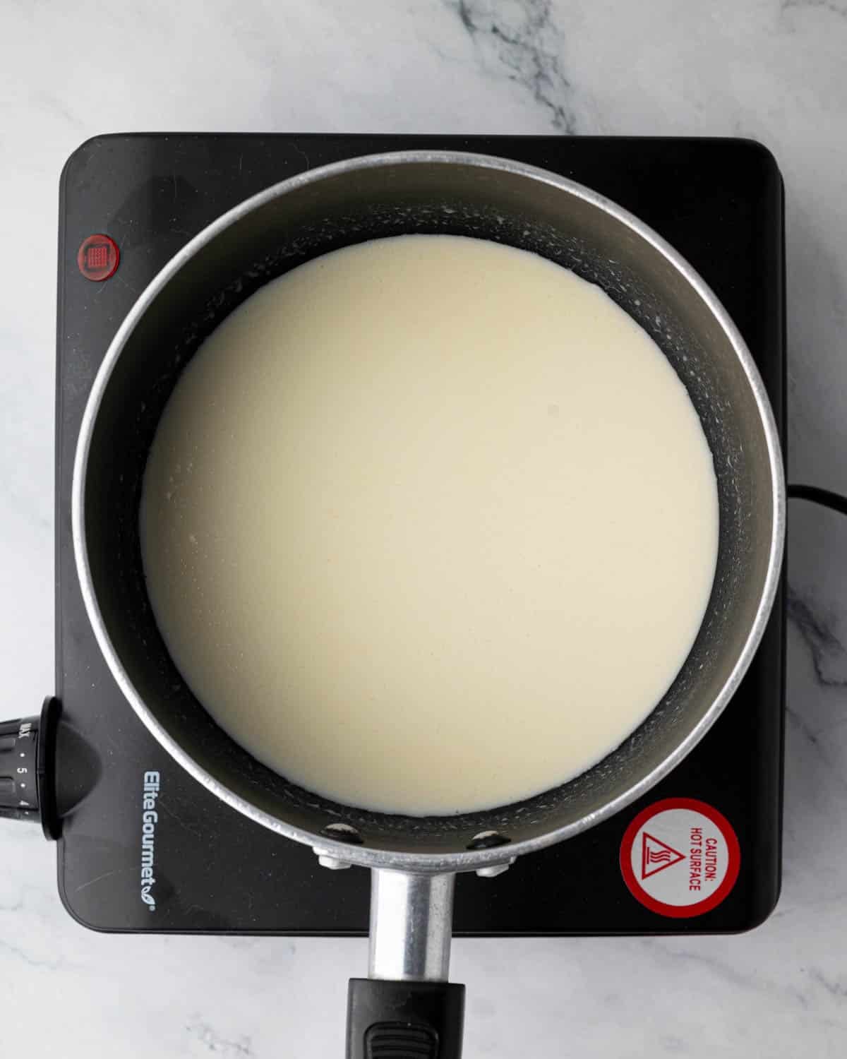 Ganache being heated in a pot.