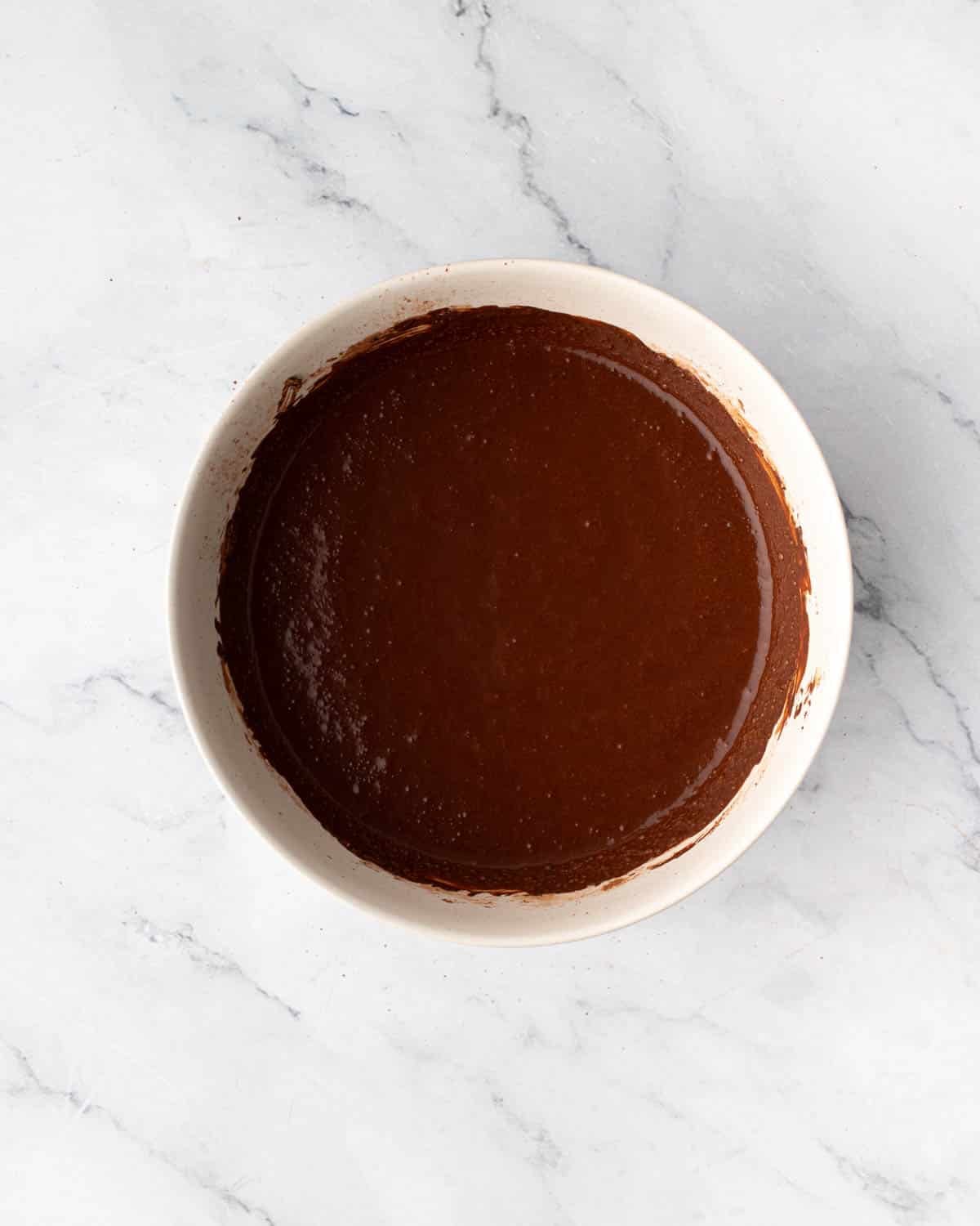 Wet chocolate cake batter in a bowl.