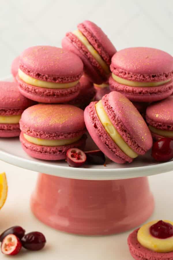 A platter of orange cranberry macarons.