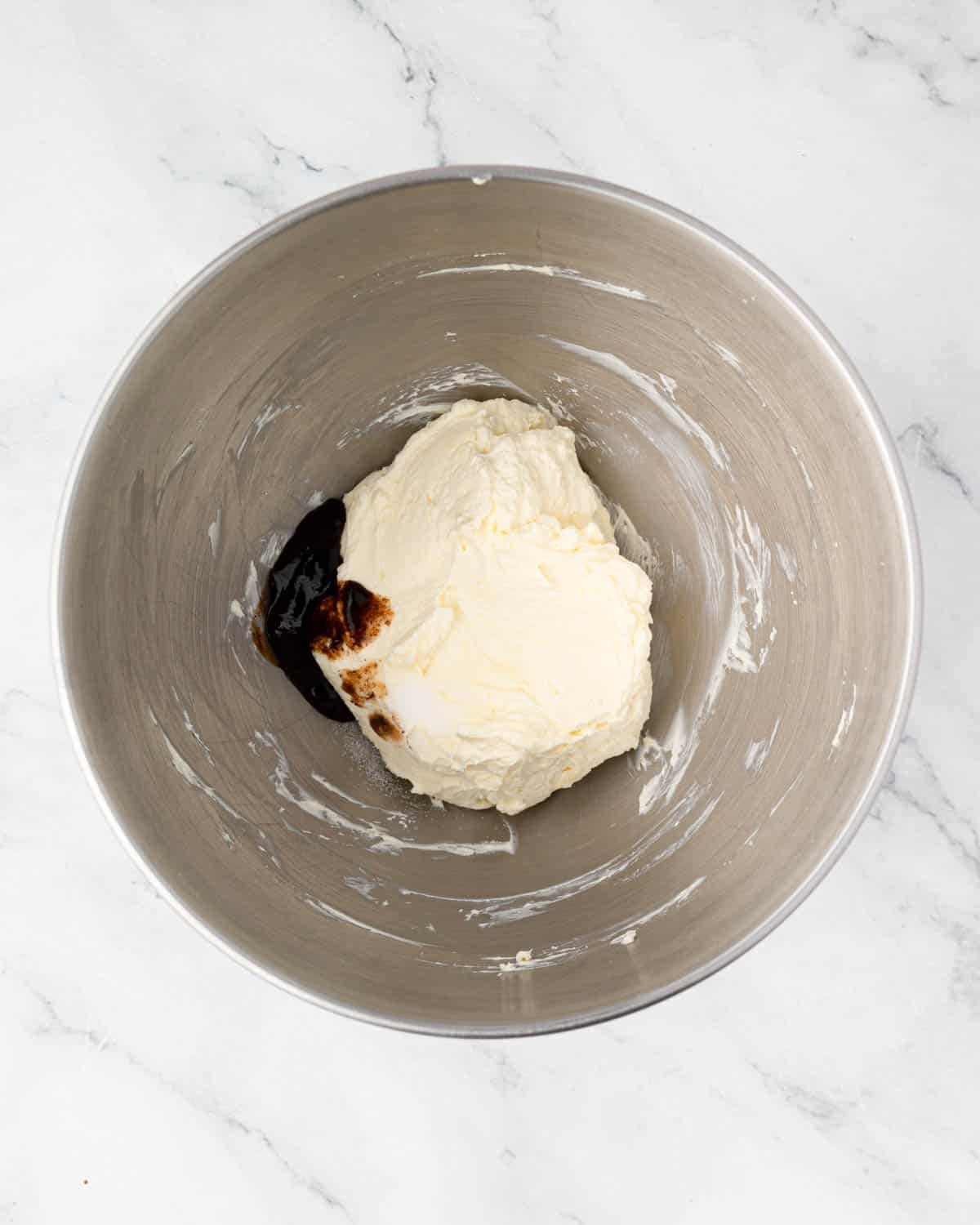 Cream cheese and vanilla in a mixing bowl.