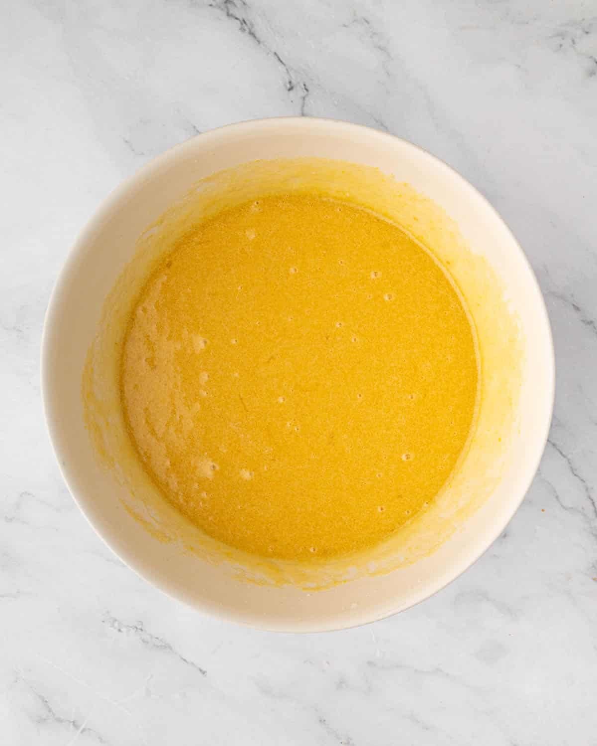 Wet ingredients for red velvet brownies combined in a bowl.