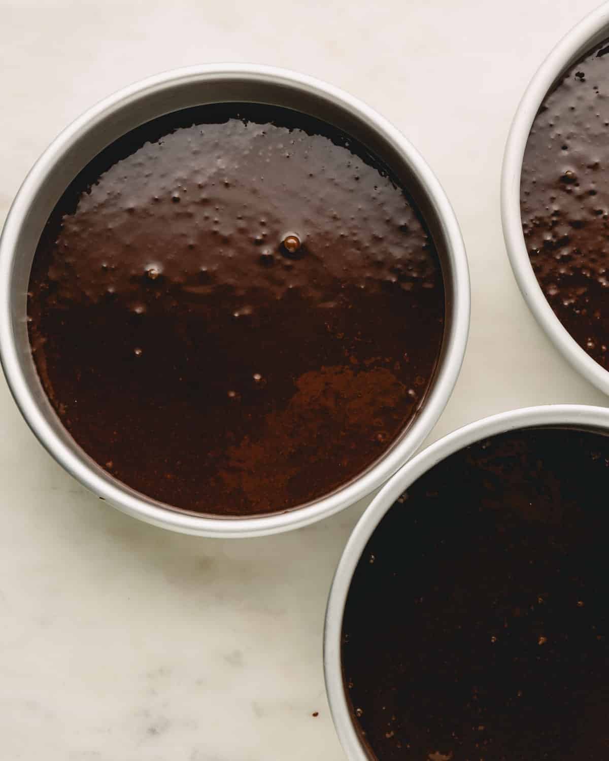 German chocolate cake batter poured into cake pans.