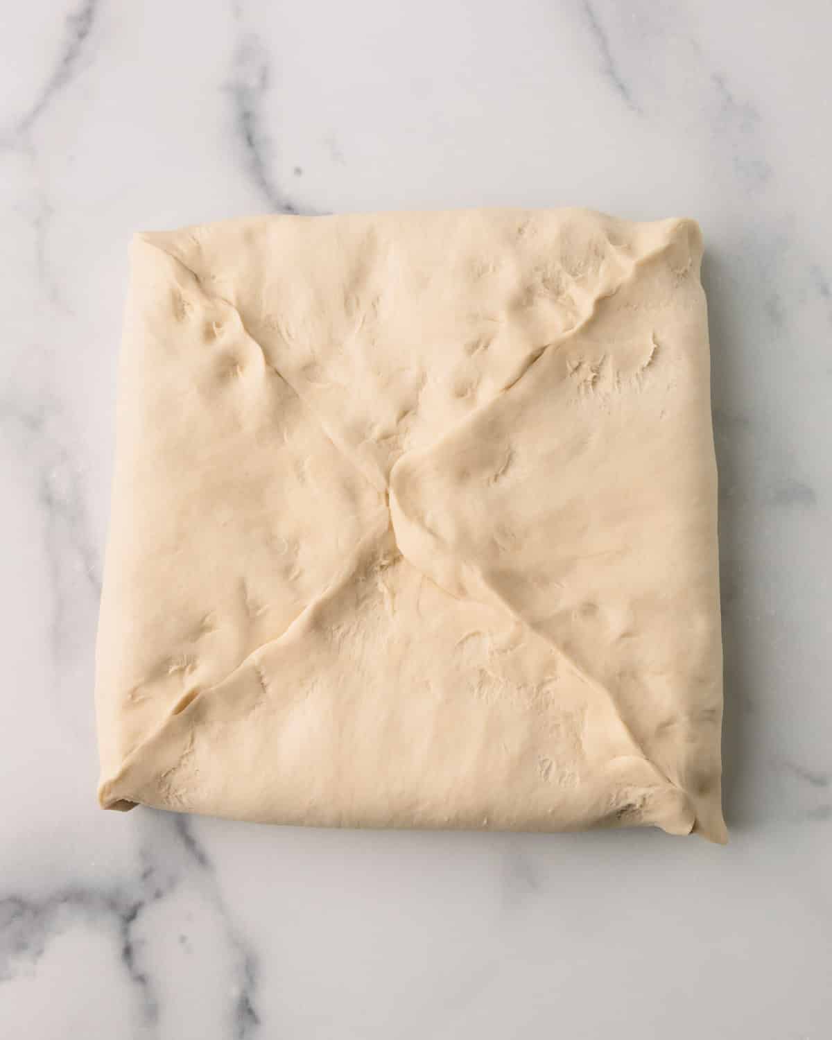Croissant dough that is folded over the butter.