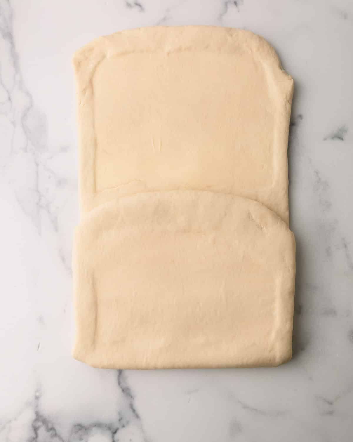 Croissant dough being folded.