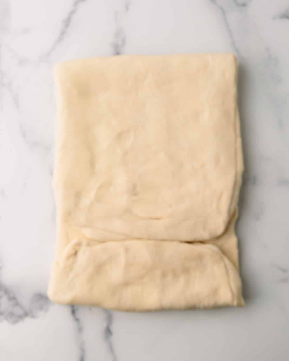 Croissant dough being folded again.
