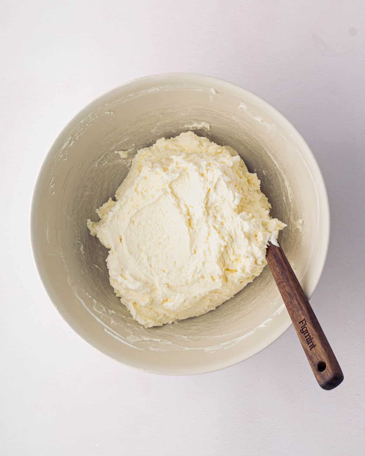 A white bowl with mascarpone whipped cream.