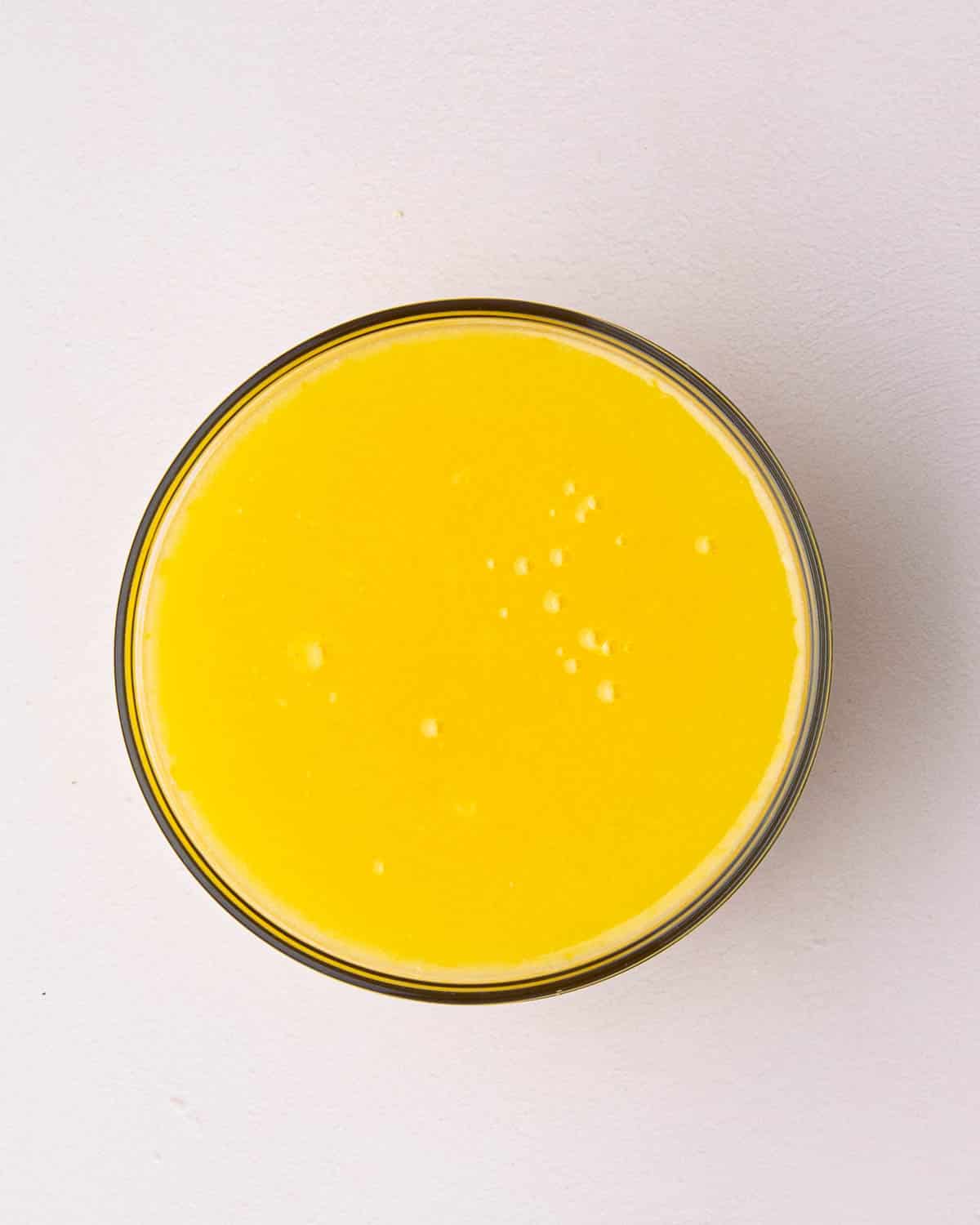 Finished lemon curd in a glass bowl.