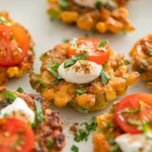 Sweet corn fritters with cherry tomatoes and sour cream.