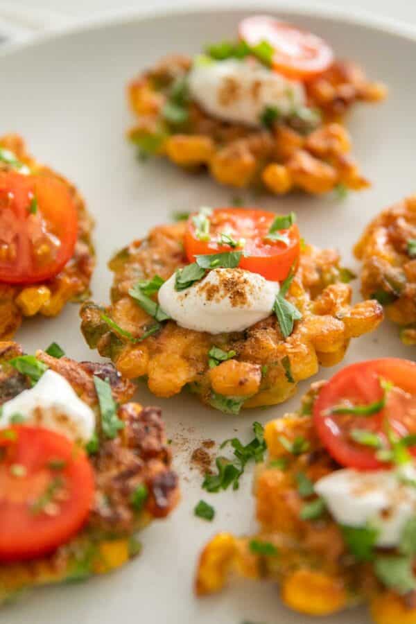 Sweet corn fritters with cherry tomatoes and sour cream.
