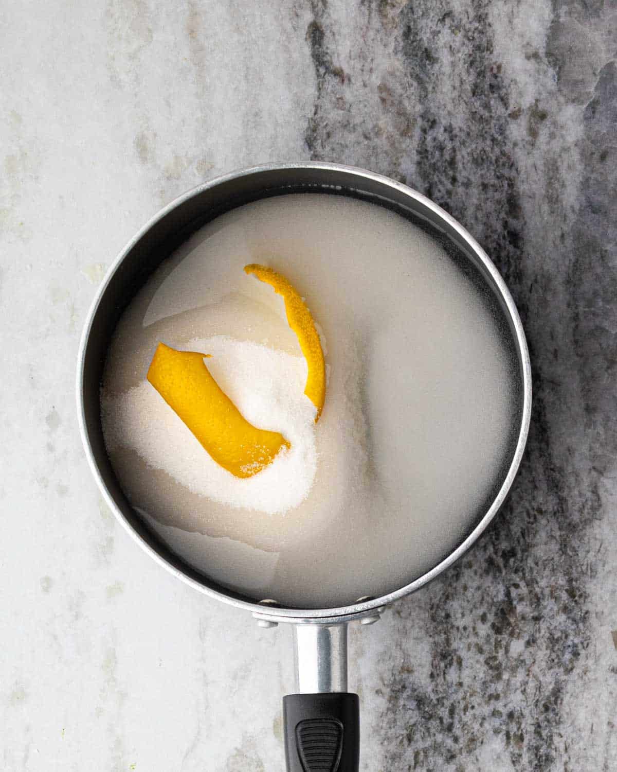 A saucepan with simple syrup being made.