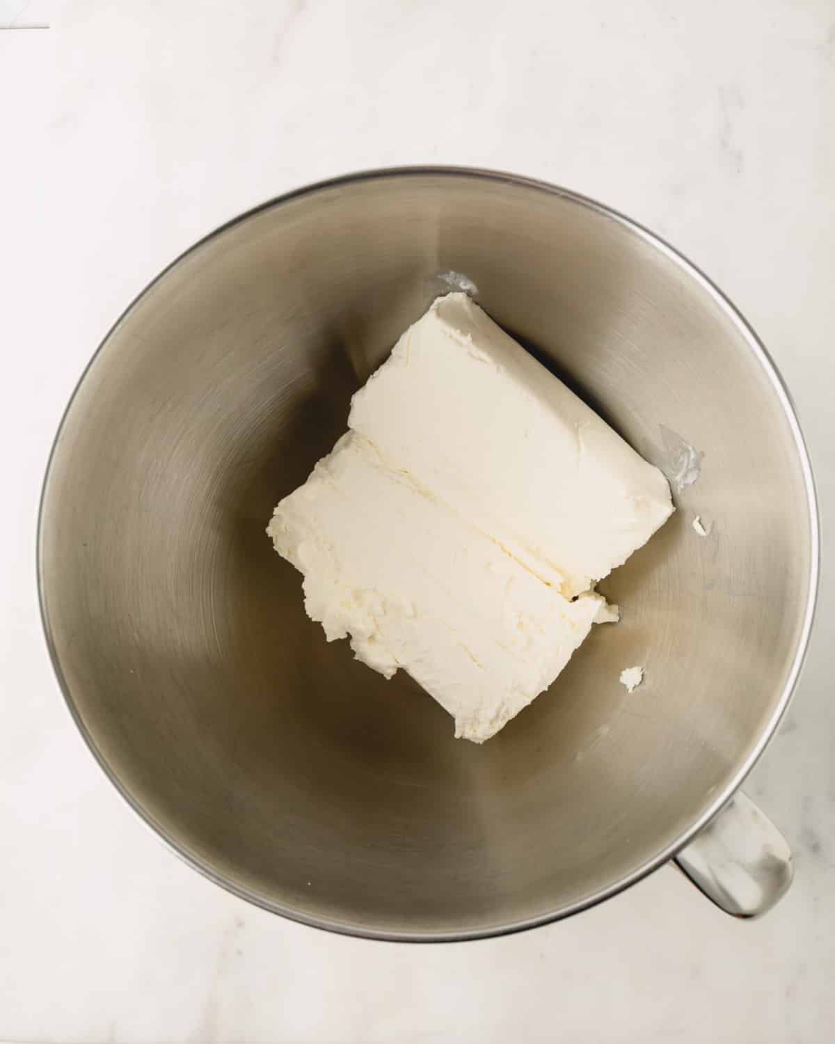 A stand mixer with cream cheese.