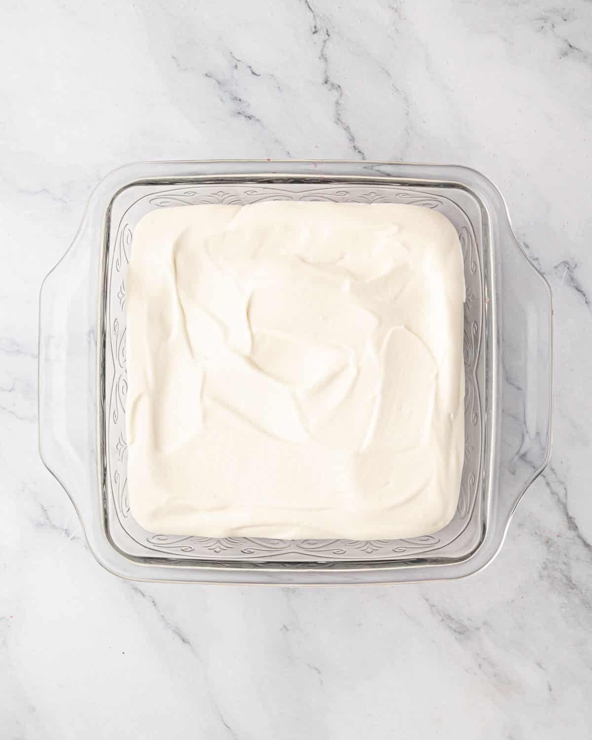 Whipped mascarpone cream is added on top of dipped ladyfingers.