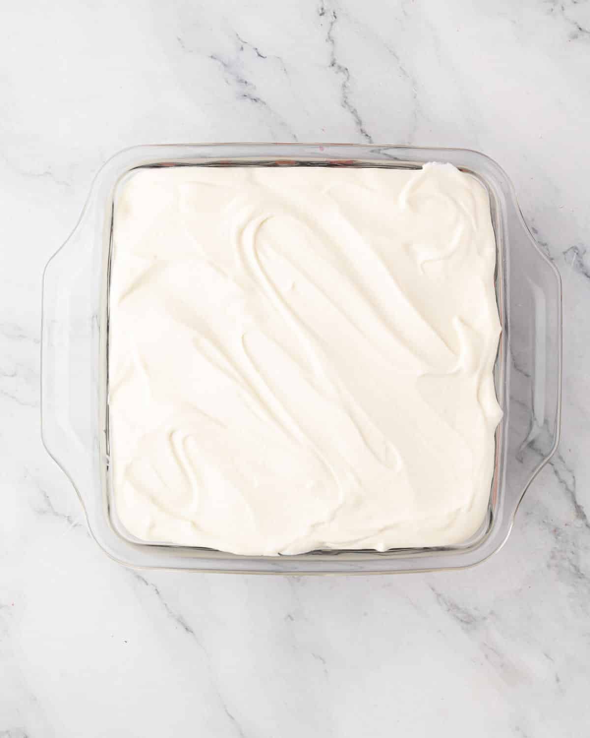 A second layer of mascarpone cream is added on top.