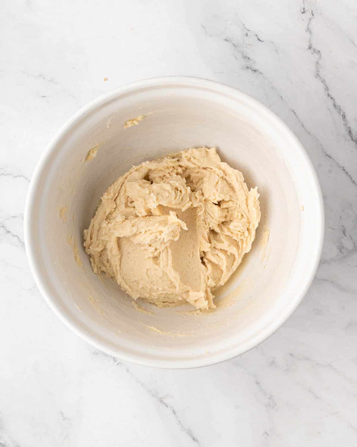 A white bowl with butter and sugar creamed.