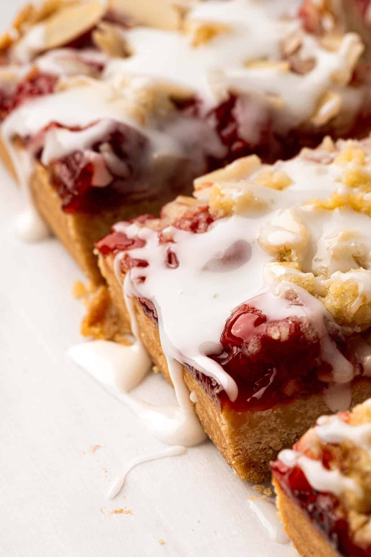Side view of iced cherry pie bars.