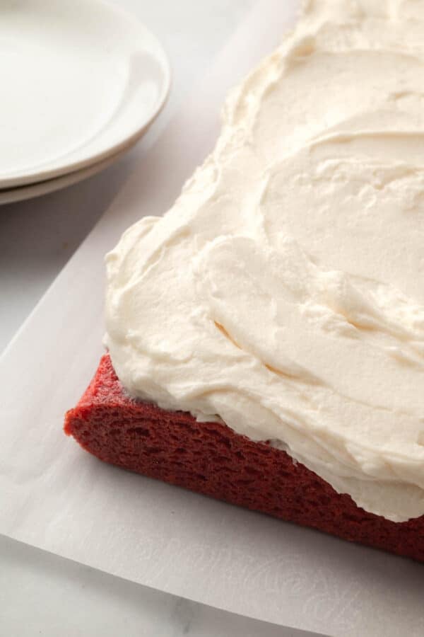 Ermine frosting spread onto a red velvet sheet cake.