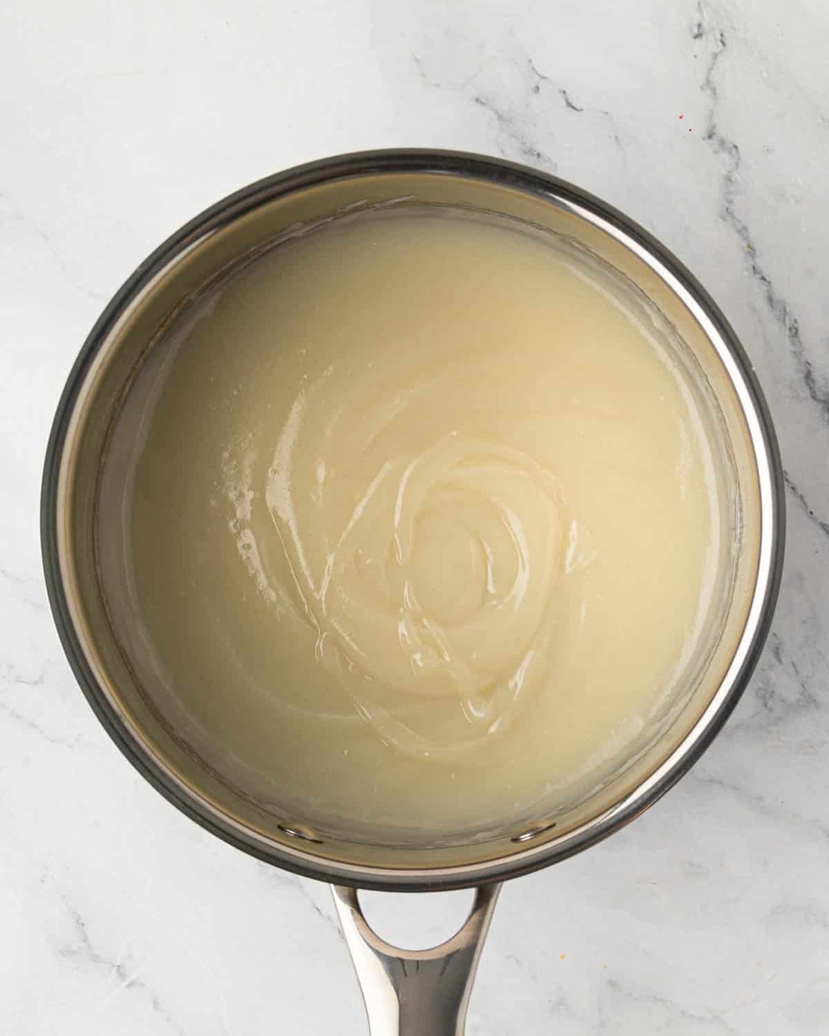 A saucepan with cooked roux for ermine icing.
