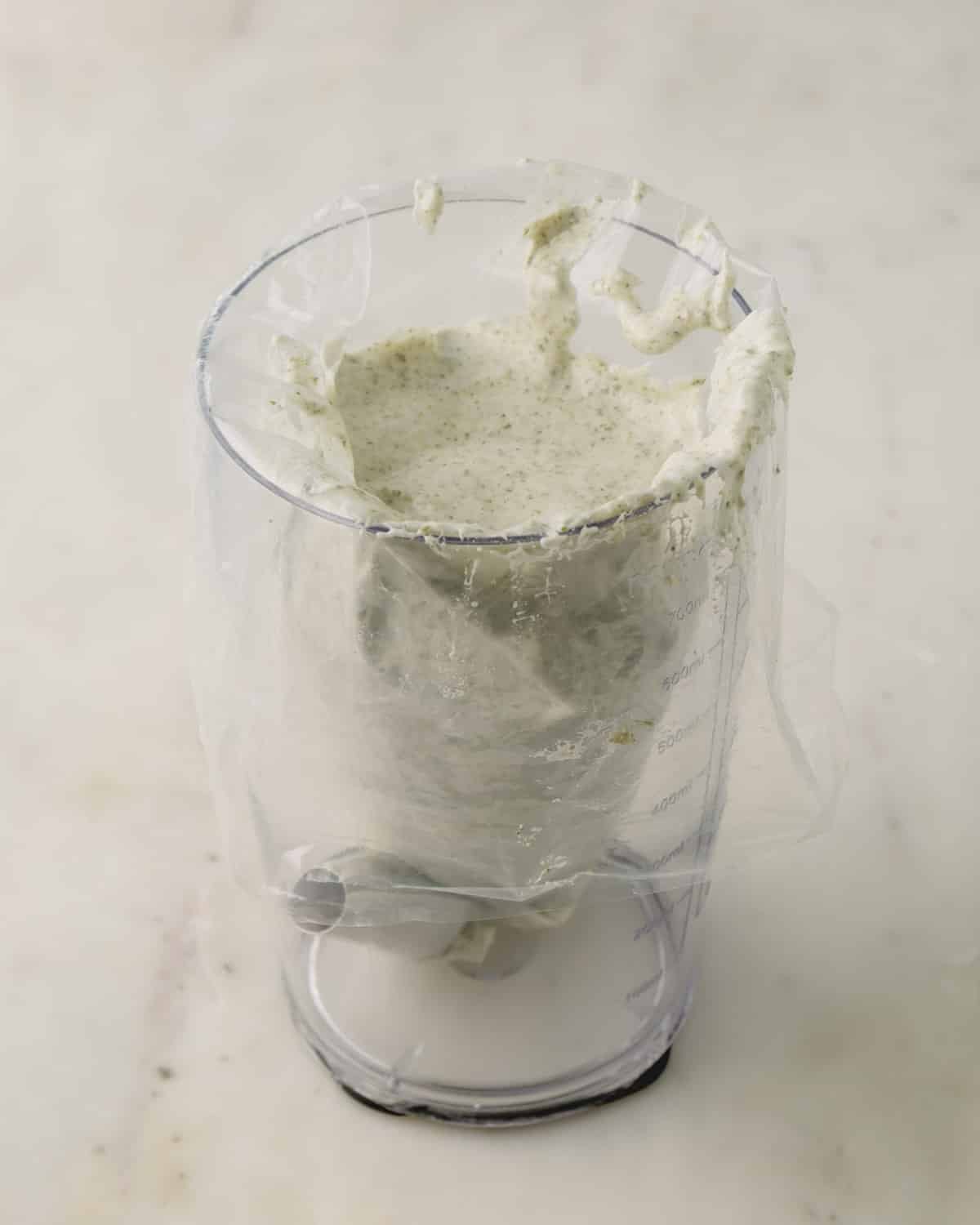 Macaron batter transfered into a piping bag with a round tip.
