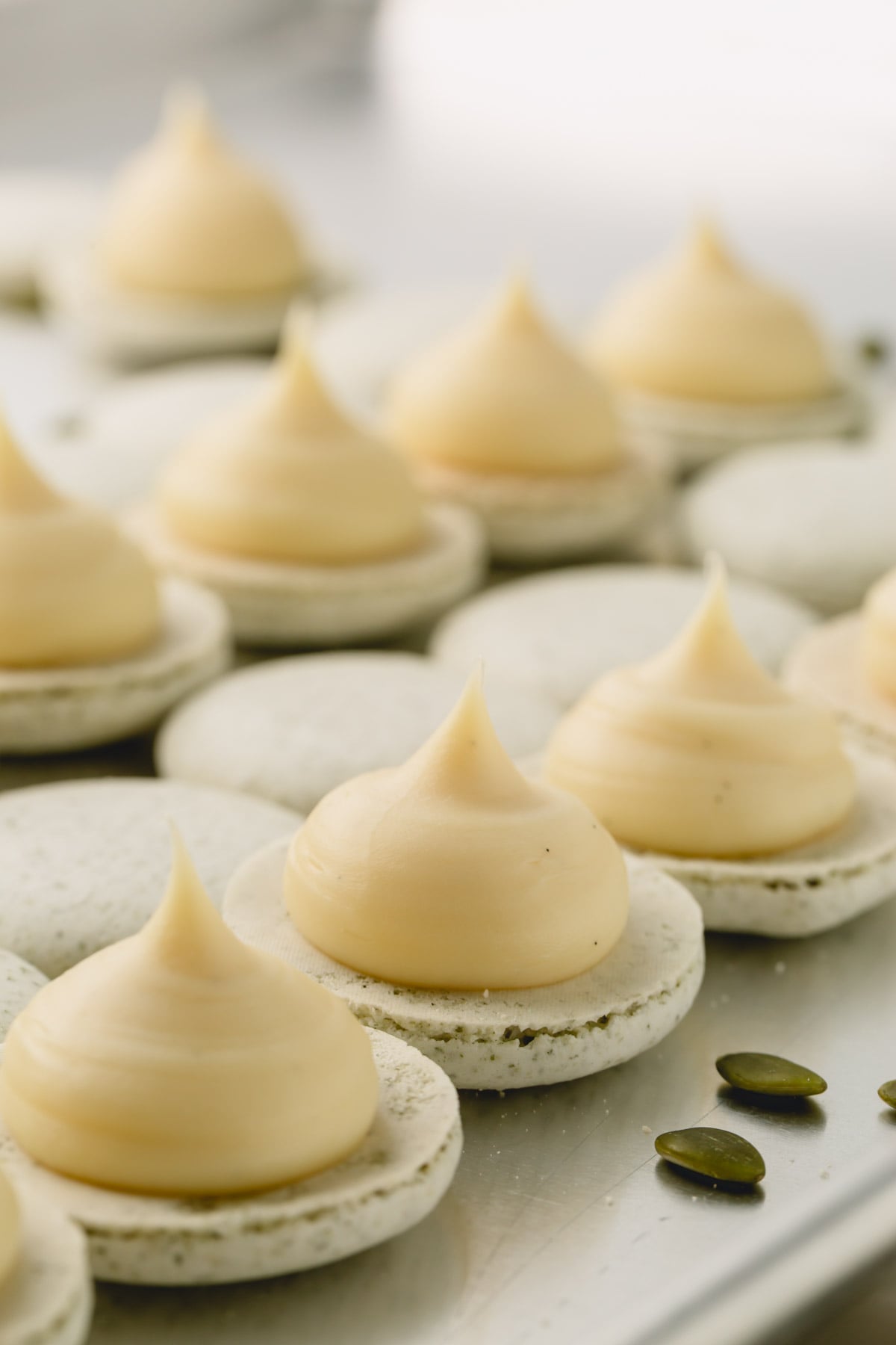 Macaron shells with a dollop of white chocolate ganache filling.