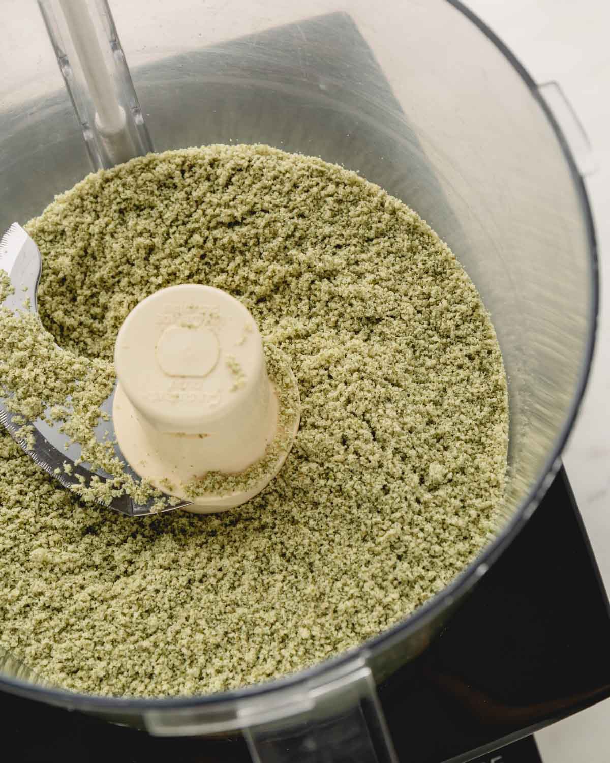 Finely ground pumpkin seeds in a food processor.