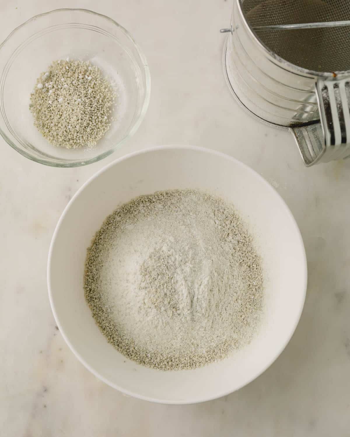 Dry ingredients sifted into a white bowl.